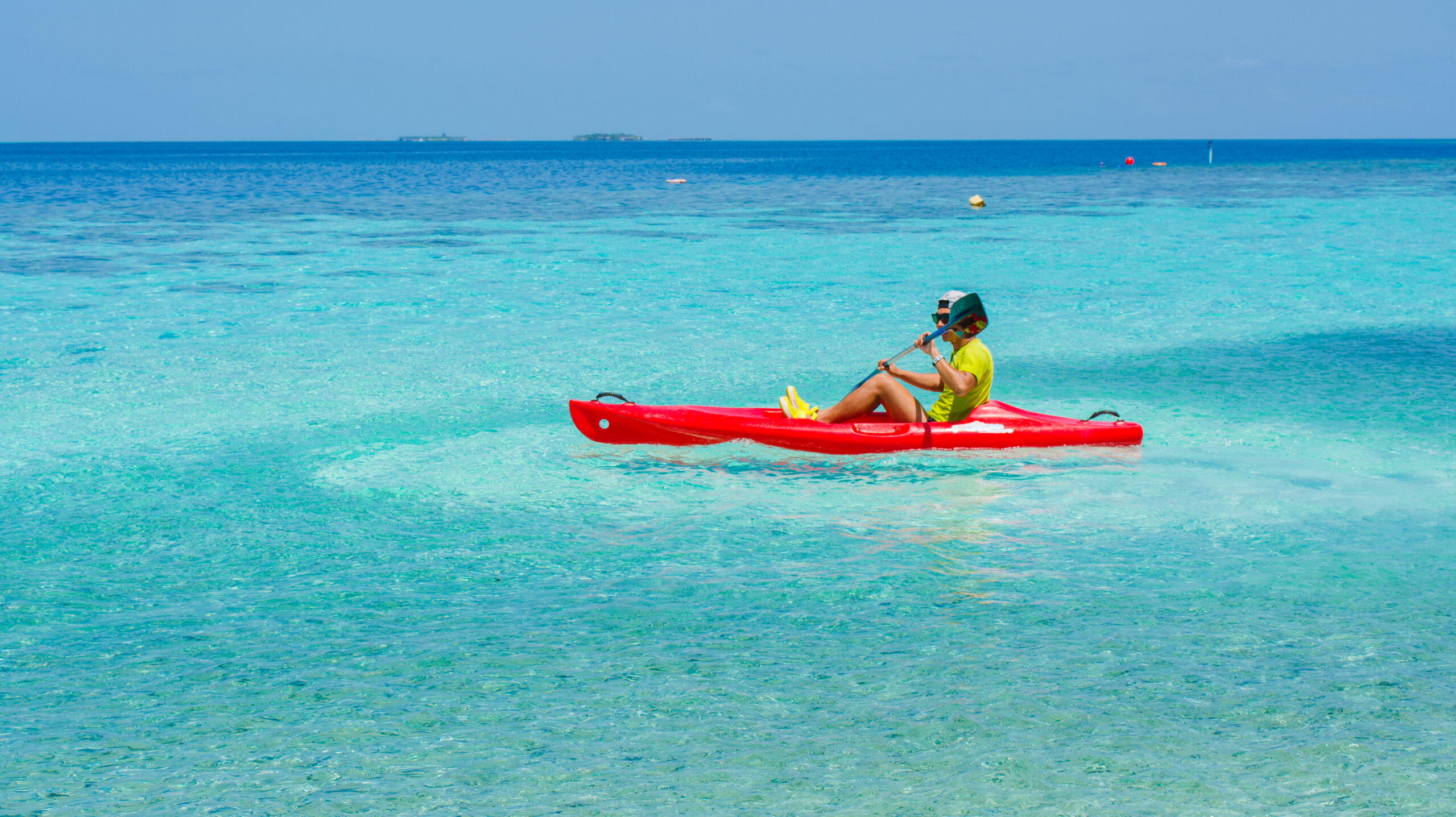 Young caucasian man kayaking in sea at Maldives - Boost up color Young caucasian